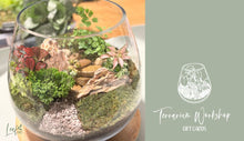 Load image into Gallery viewer, Promotional image for Terrarium Workshop Gift Card, featuring a large-sized terrarium with a variety of plants and decorative elements like stones.